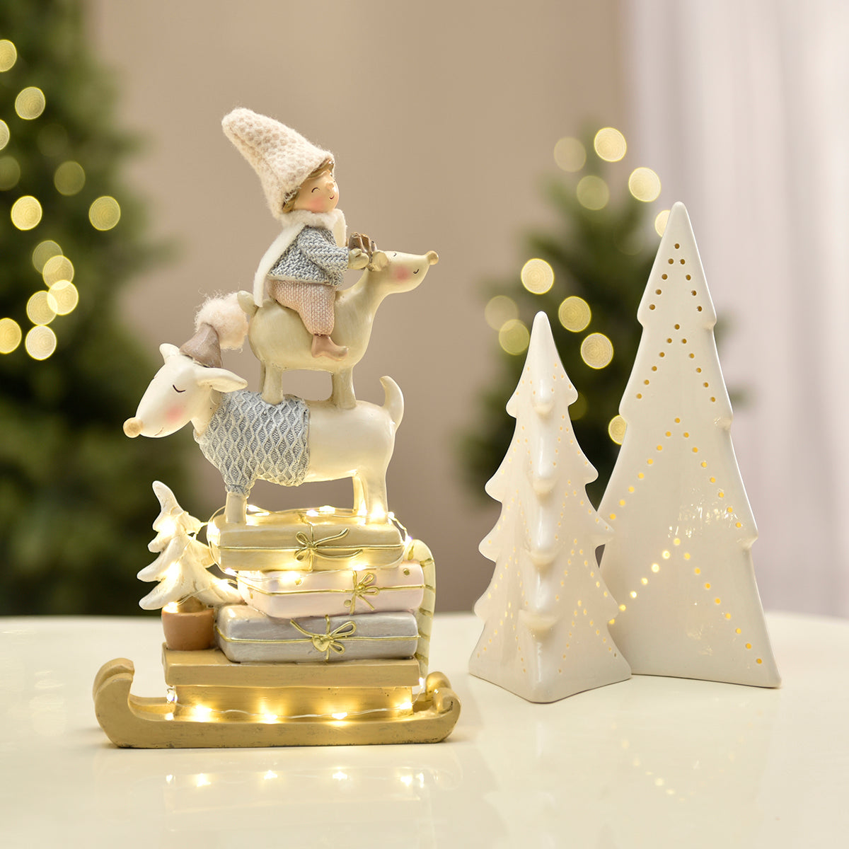 Figurine de Noël Enfant sur renne Pastel