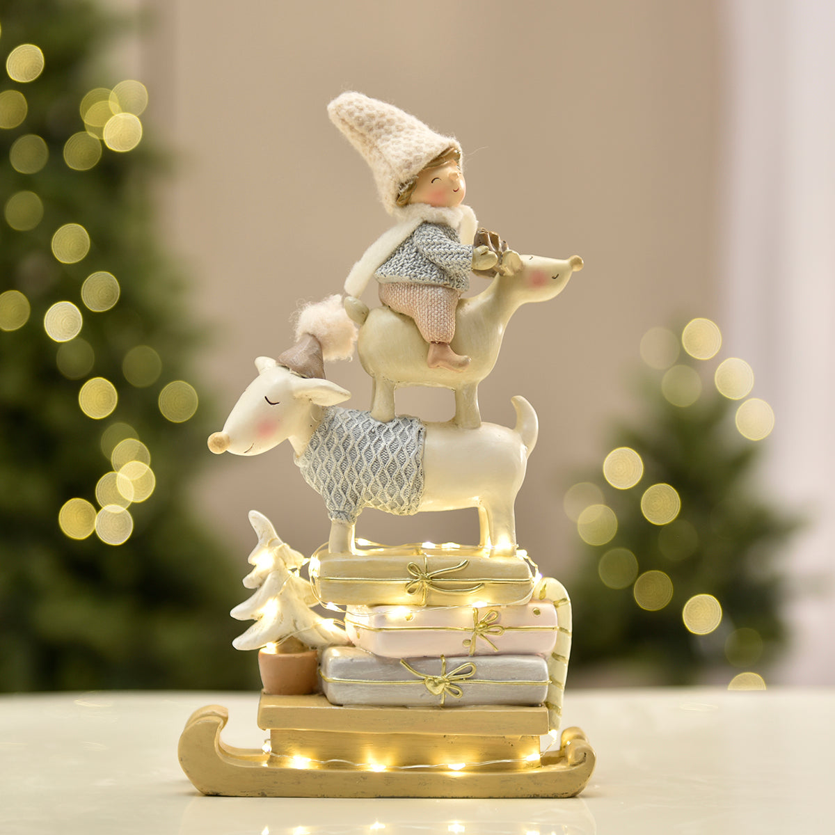 Figurine de Noël Enfant sur renne Pastel